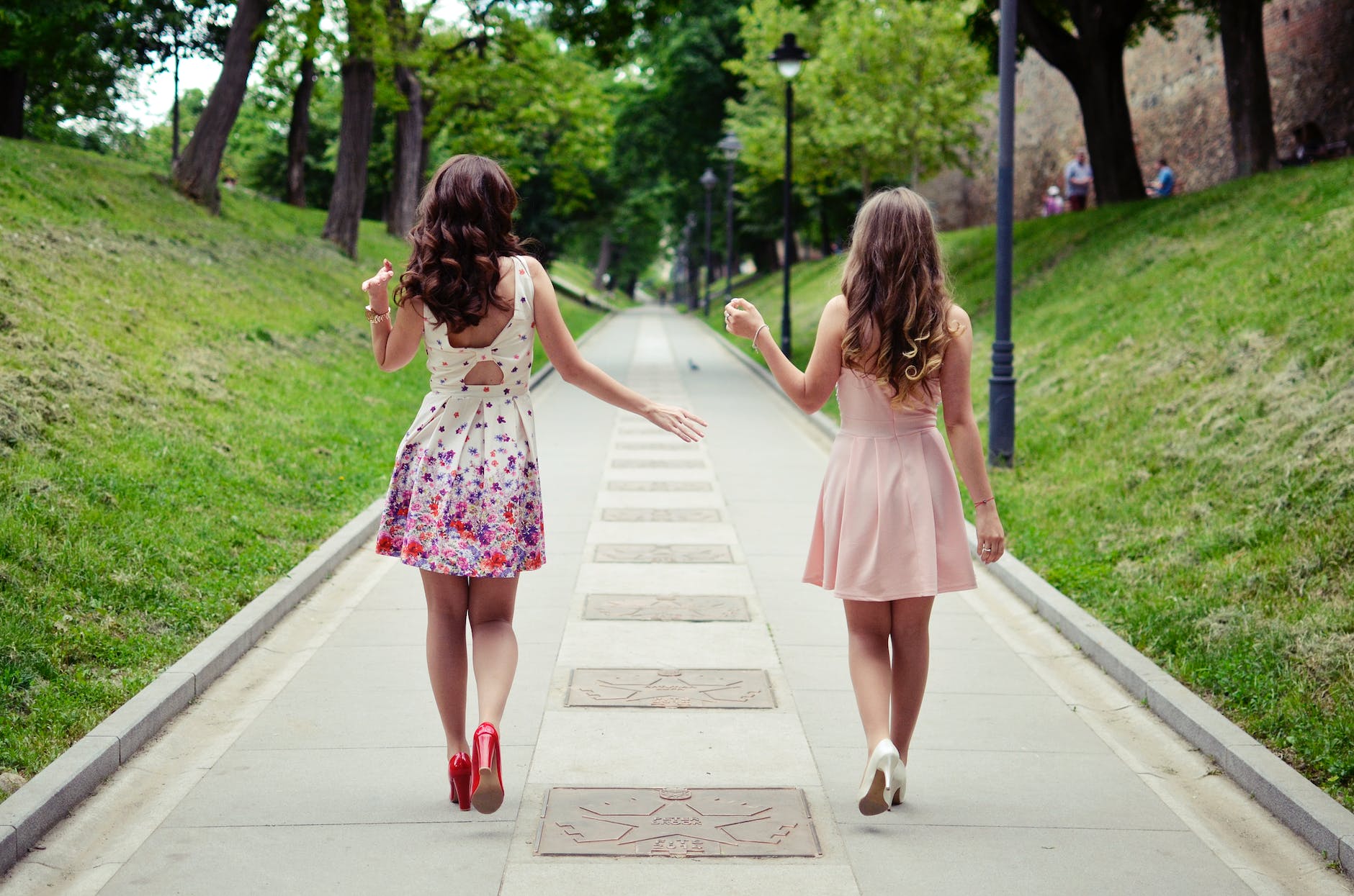 two women walking on pathway