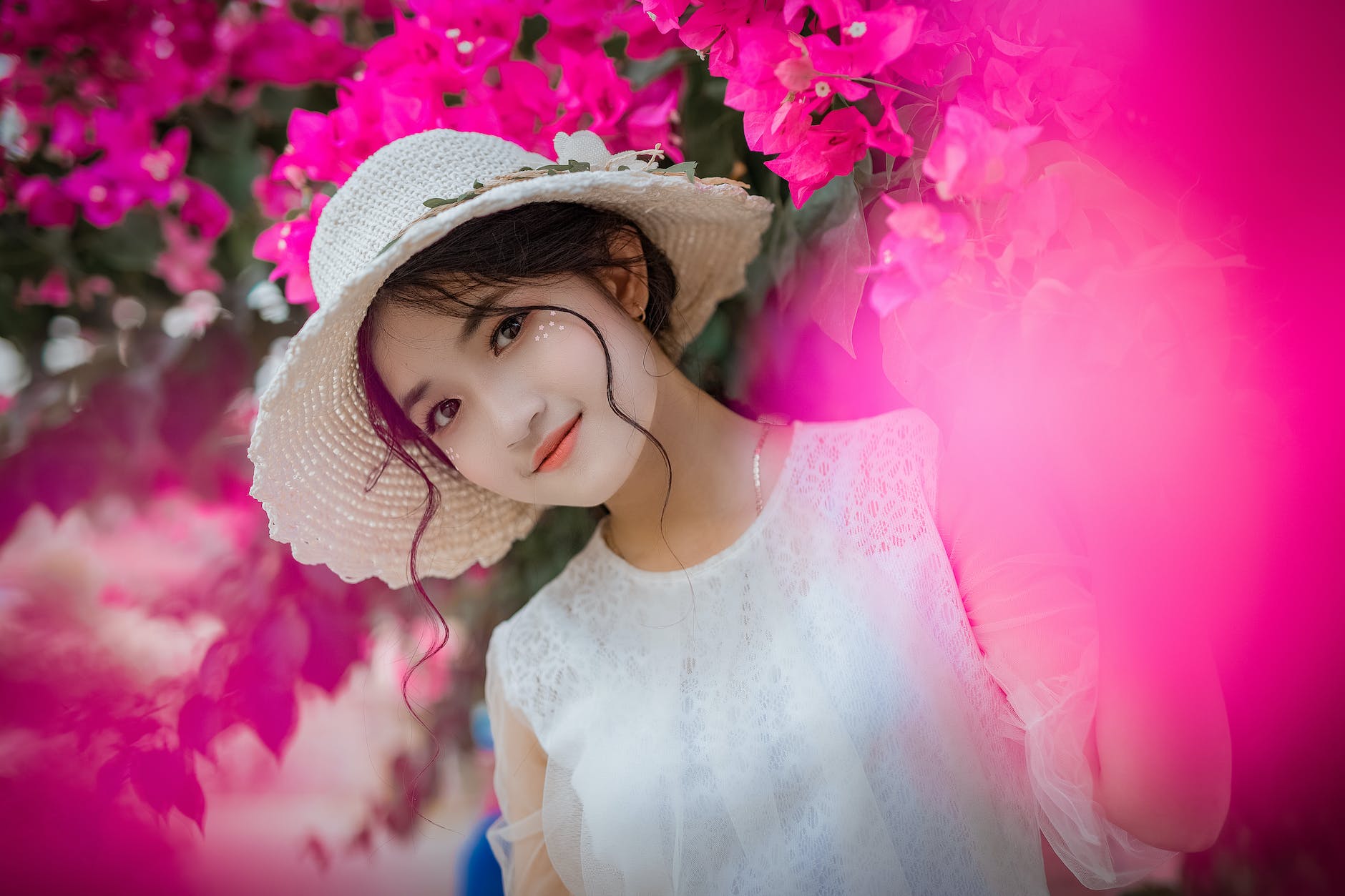 woman surrounded by pink bougainvillea flowers